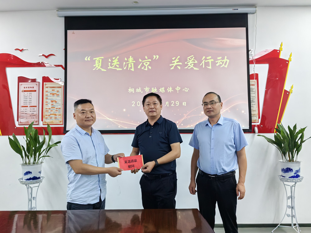 图为市融媒体中心党组书记、主任徐基胜和党组成员、副主任吴文舟为派驻尧天村第一书记周文艺送上慰问金。.jpg